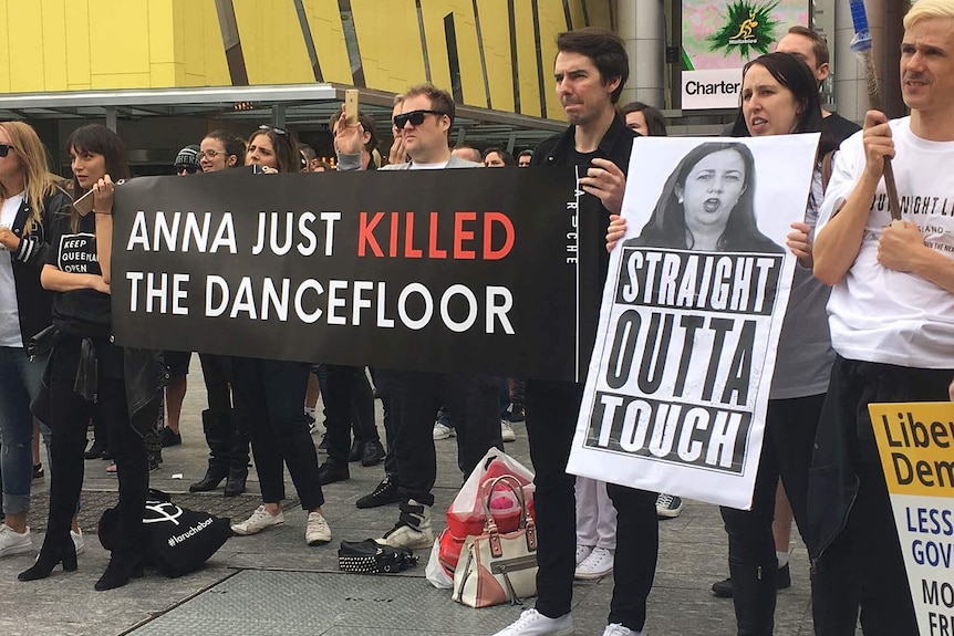 Protesters hold banners opposing lockout laws at a Brisbane rally