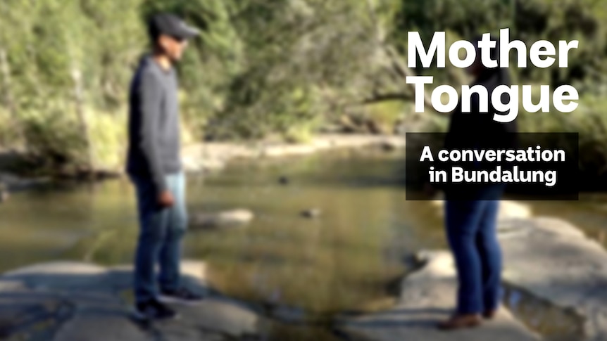 A man and woman stand beside a lake, text overlay reads 'Mother Tongue A conversation in Bundalung'