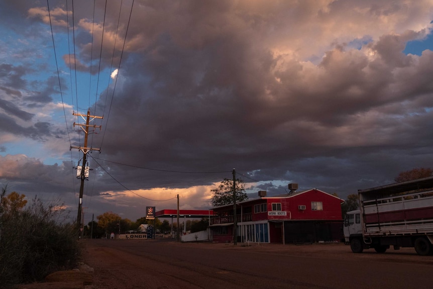 Storm clouds brew over a petrol station in the outback.