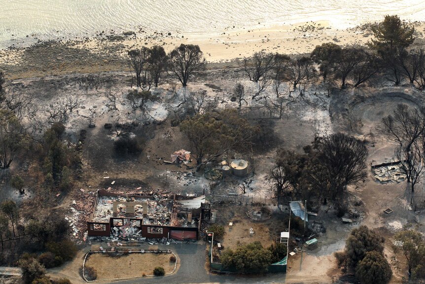 A house damaged by a bushfire is seen from a helicopter in Boomer Bay, Tasmania.