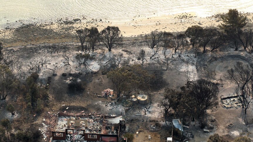 A house damaged by a bushfire is seen from a helicopter in Boomer Bay, Tasmania.