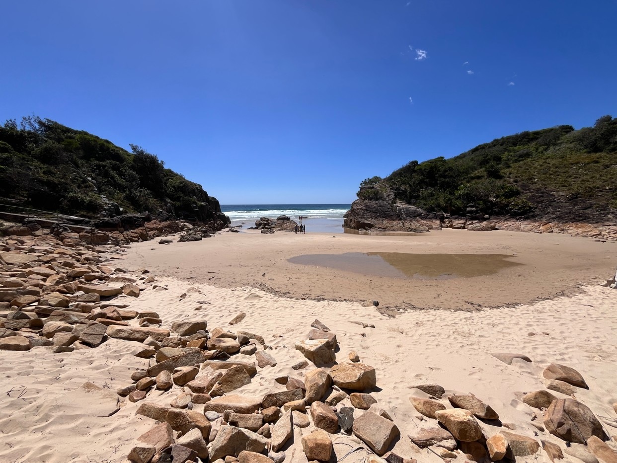 A small sandy beach flanked on either side by headlands