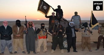 ISIS militants wave flags