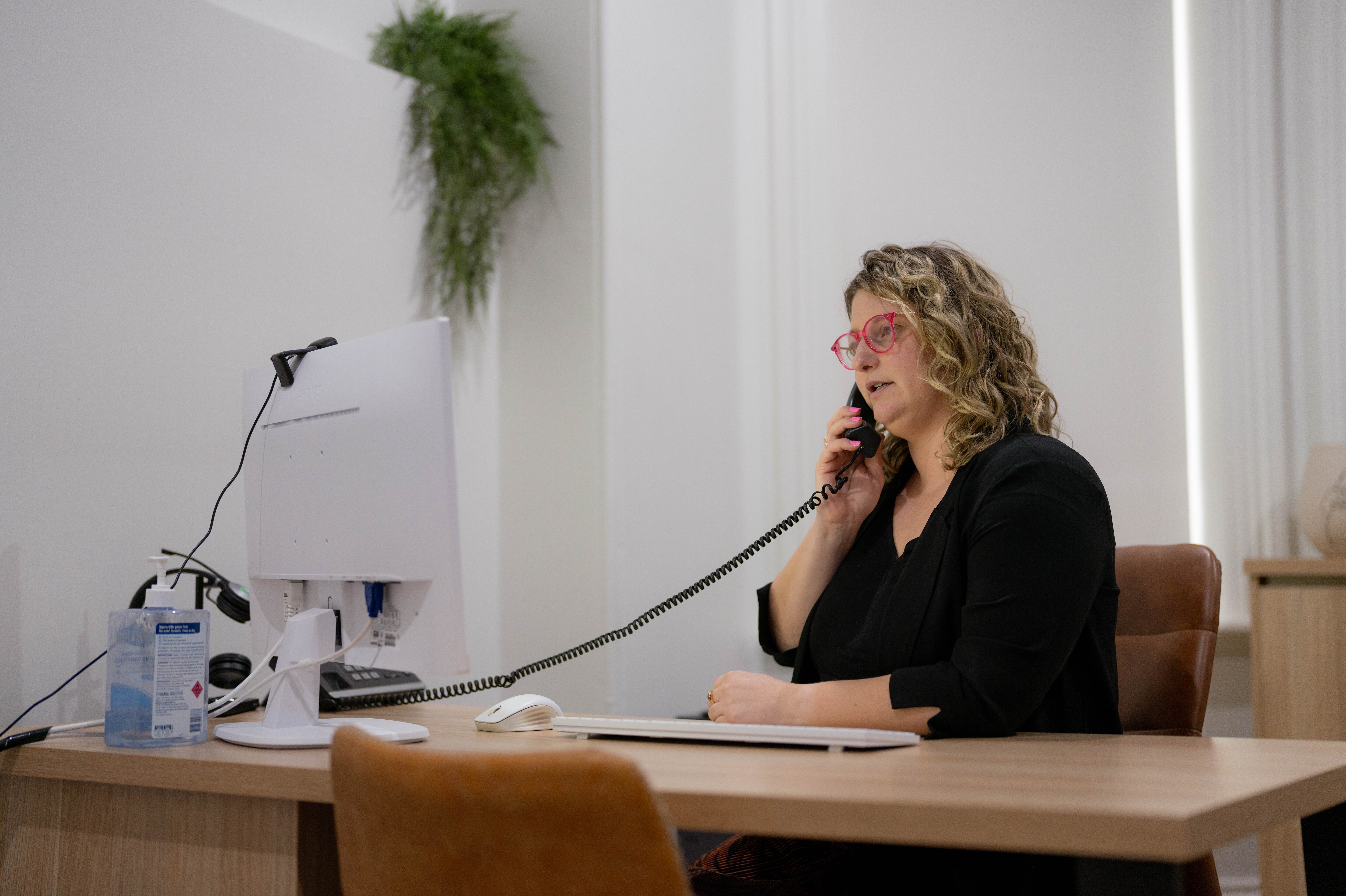 A woman takes a phone call in her office