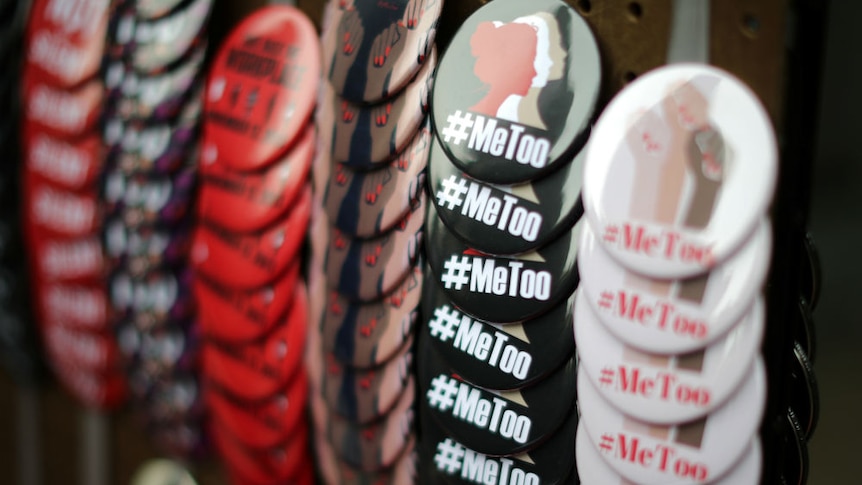 A vendor sells #MeToo badges a protest march