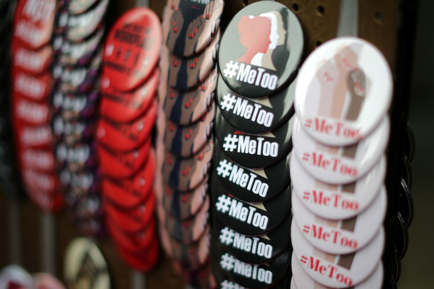 A vendor sells #MeToo badges a protest march