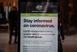 A government notice about coronavirus in a doorway.