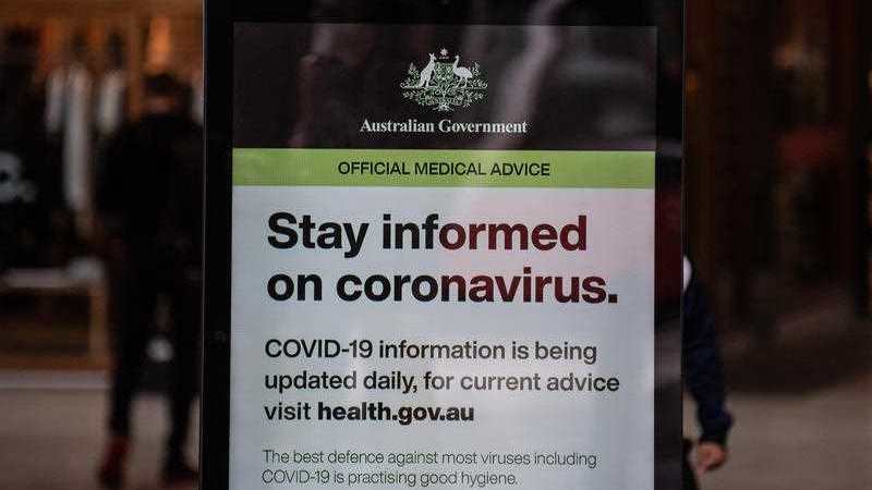 A government notice about coronavirus in a doorway.