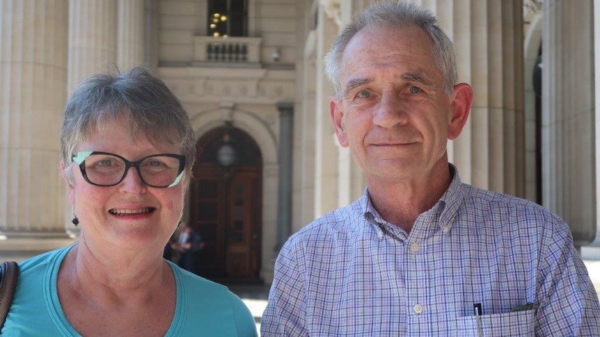 Jen and Ken Barnes standing on the steps of Victoria's parliament