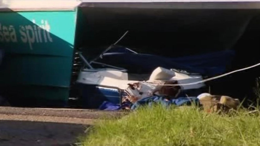 A speedboat lies wedged under a Sydney ferry