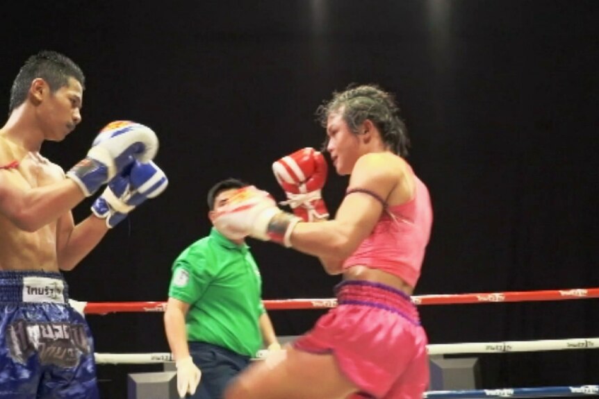 Transgender kickboxer Somros Polchareon takes on her opponent in the ring