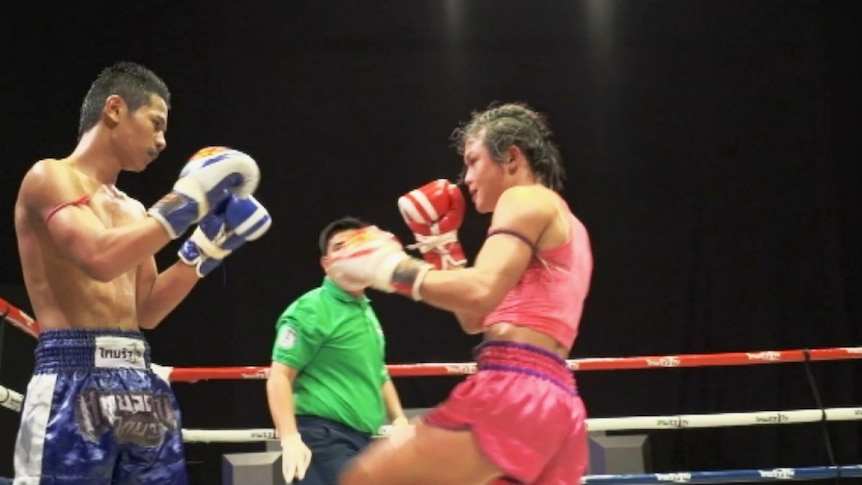 Transgender kickboxer Somros Polchareon takes on her opponent in the ring