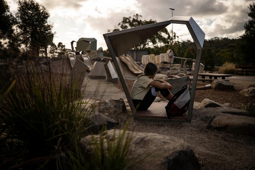 Photo of a young girl sad at a playground