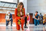 House Speaker Nancy Pelosi and other members of Congress kneel and observe a moment of silence at Emancipation Hall.