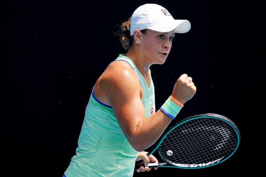Ash Barty looks into the crowd and clenches her right fist.