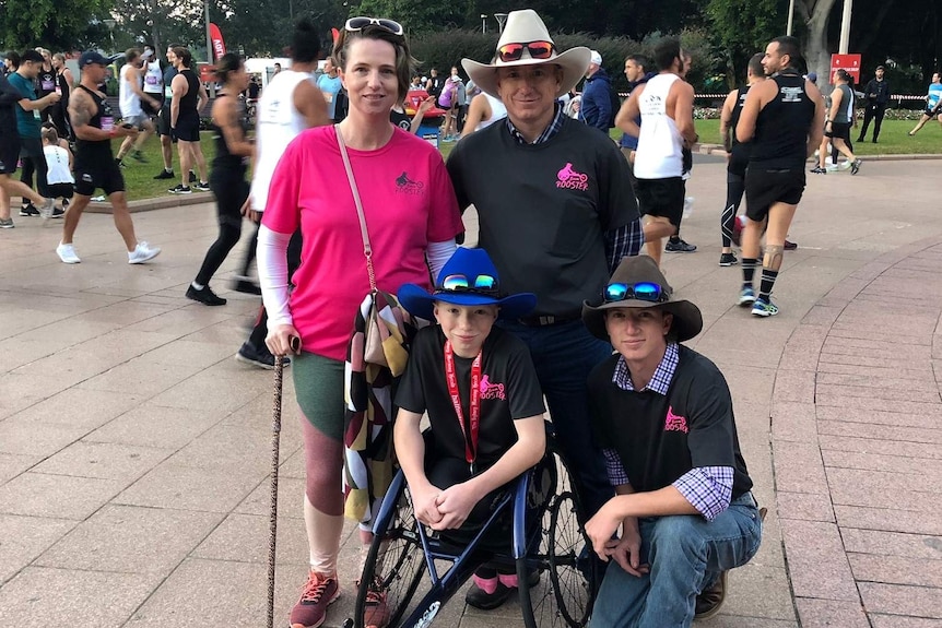 A family pose for a shot in front of the camera