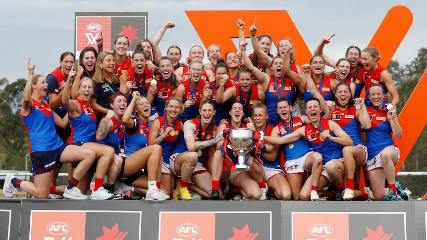 Melbourne celebrates on stage with the AFLw premiership cup after winning the grand final.