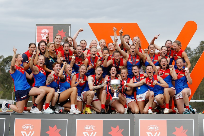 Melbourne celebrates on stage with the AFLw premiership cup after winning the grand final.