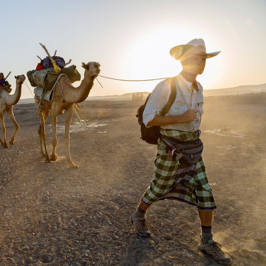 Paul Salopek leads pair of camels across the Afar desert