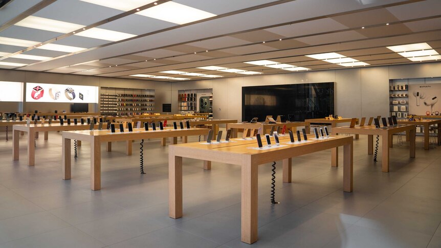 Rows of wooden tabled filled with the latest iphones and tablets