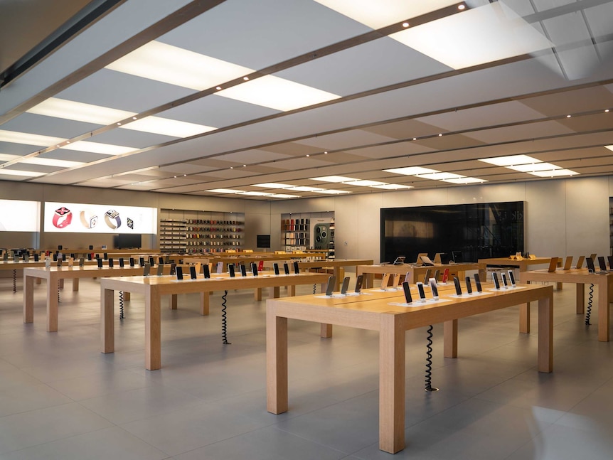 Rows of wooden tabled filled with the latest iphones and tablets