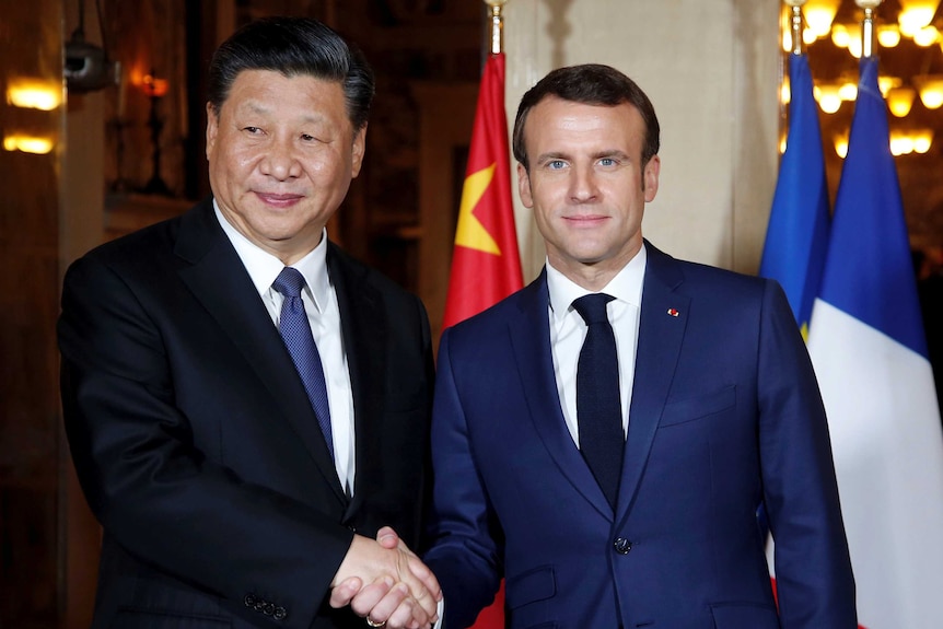 Chinese President Xi Jinping, left, is welcomed by French President Emmanuel Macron