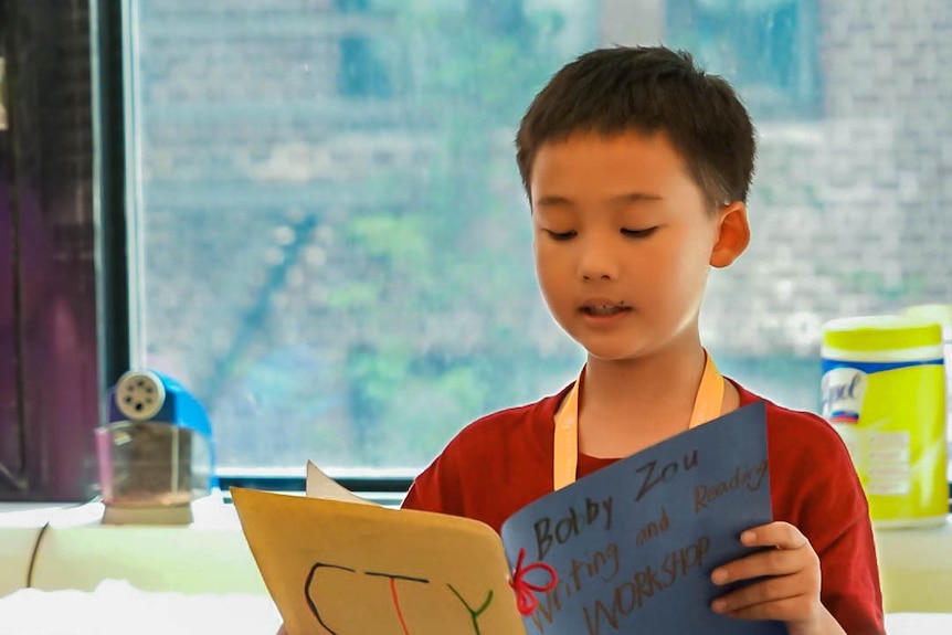 Bobby reading work in front of the class