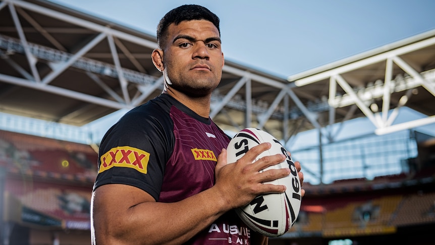 A rugby league player stares at the camera during a photoshoot