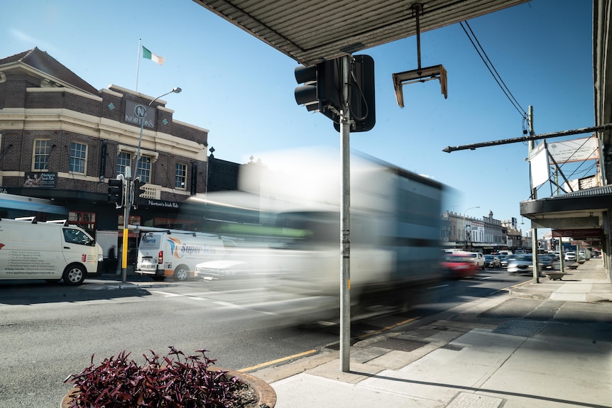 Trucks whizz through a busy intersection in Sydney
