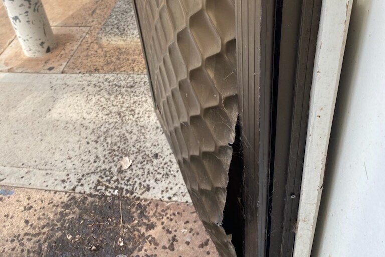 A damaged brown screen door.