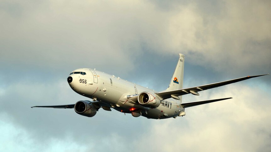 A P-8A Poseidon surveillance plane conducts a flyover on February 3, 2012
