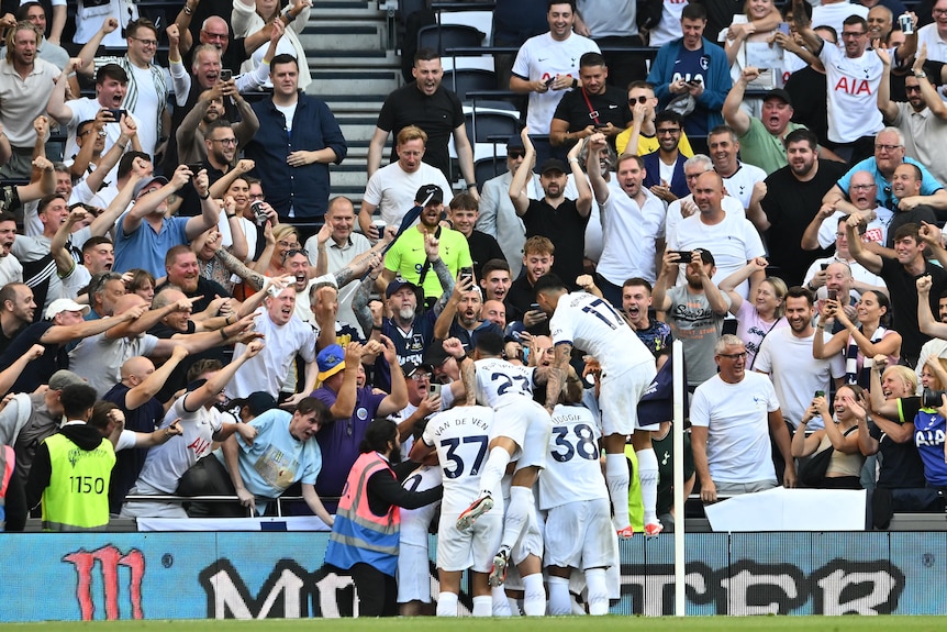 Spurs players celebrate in front of their supporters