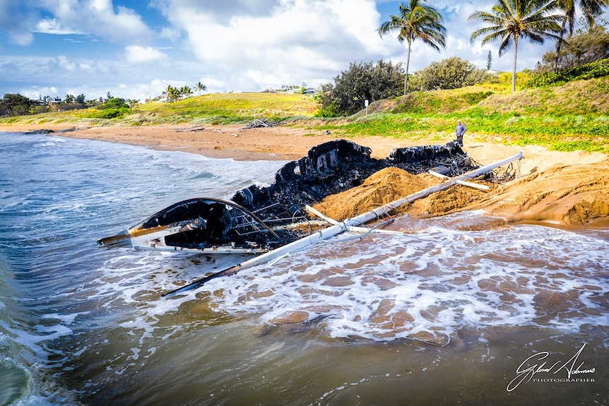 A destroyed yacht washed up on a beach