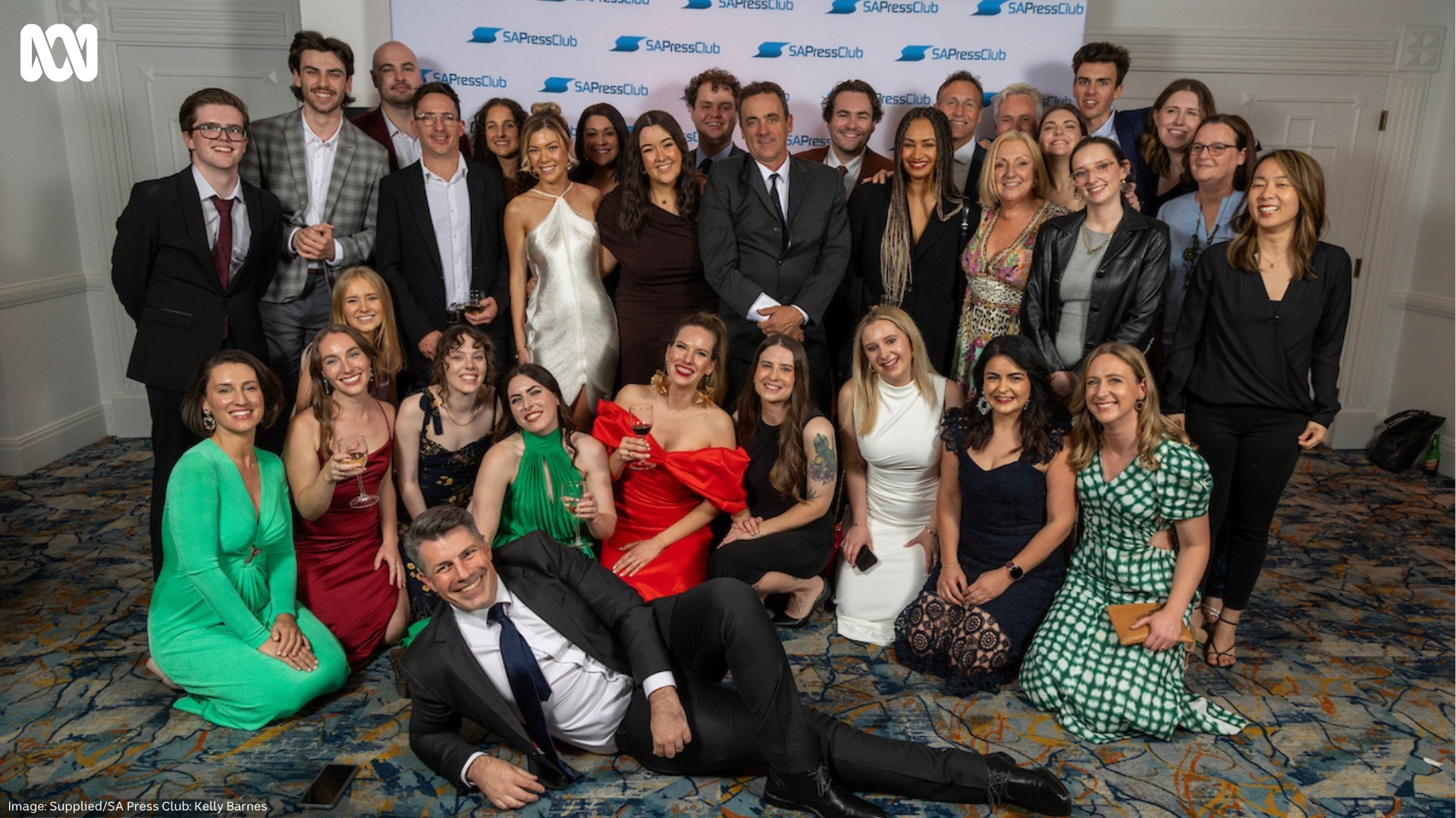ABC SA team in front of a media wall at the SA Press Club Awards