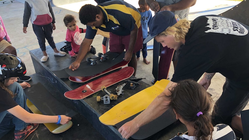 Children in Murgon, Queensland being taught how to build a skateboard.