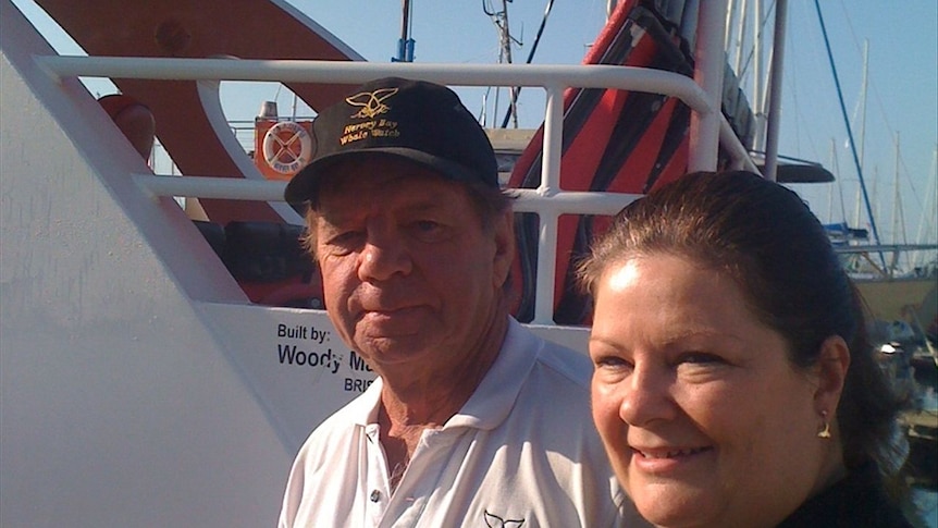 A man and a woman on a whale watching vessel
