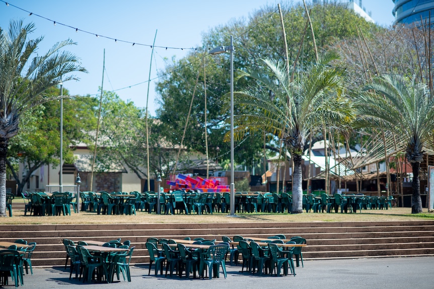 Tables and chairs are seen empty at Festival Park, Darwin Festival.