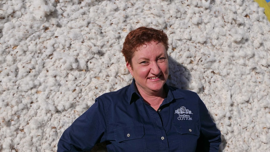 Southern Cotton general manager Kate O'Callaghan stands against a bale of cotton.