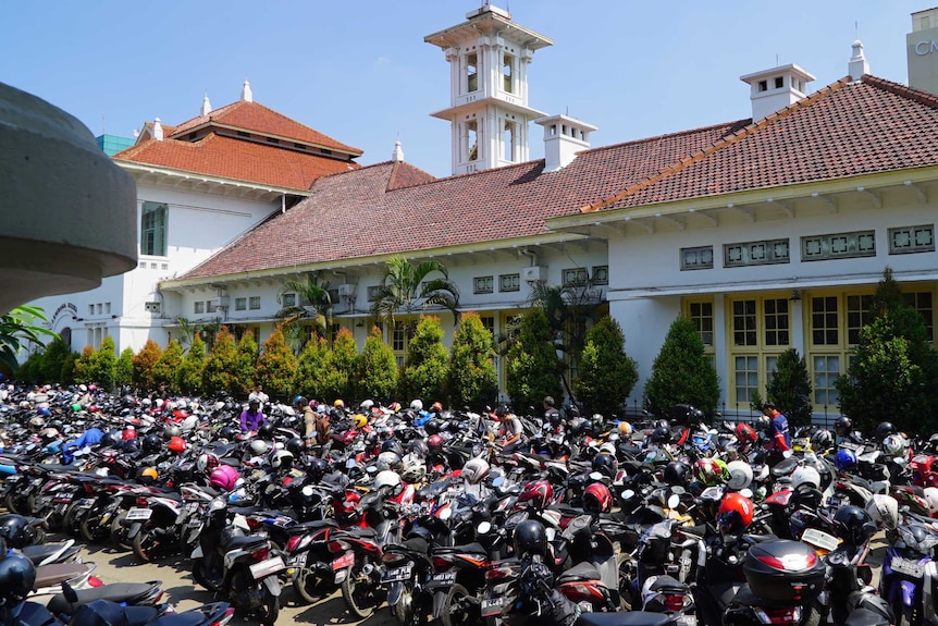 Hundreds of motorbikes are seen parked outside a hospital in Jakarta.