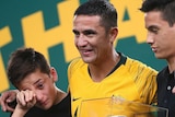 Tim Cahill stands with his family after final Socceroos match