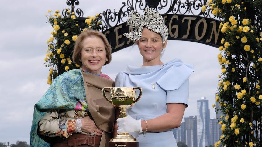Trainer Gai Waterhouse and Melbourne Cup-winning jockey Michelle Payne stand at Flemington racecourse with the Melbourne Cup.