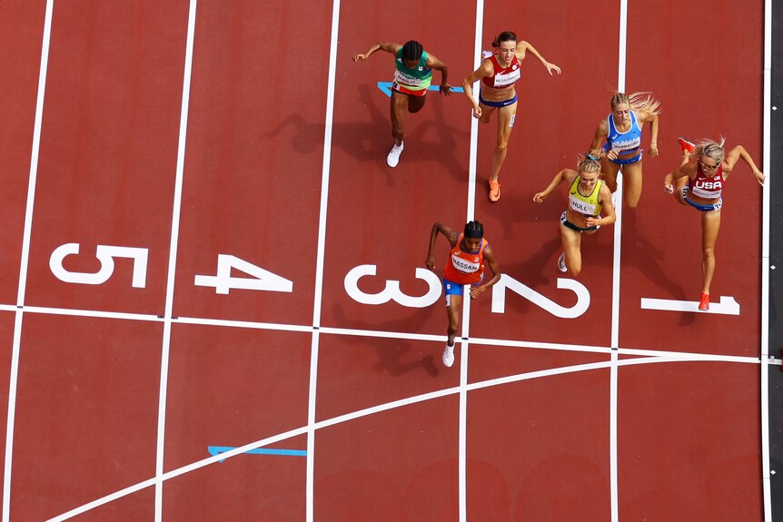 Women crossing the finish line during a 1,500m heat at the Olympics