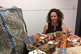 Gabrielle Sullivan with her collection of fake Aboriginal-style souvenirs