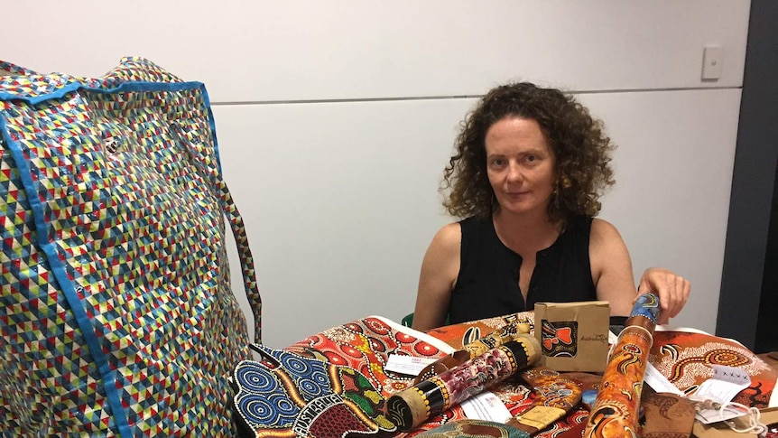 Gabrielle Sullivan with her collection of fake Aboriginal-style souvenirs