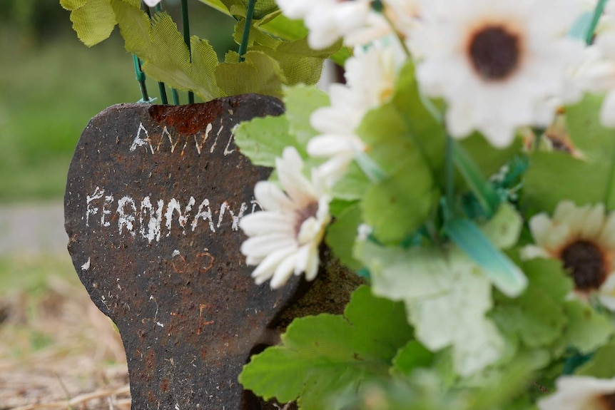 Cast iron cemetery peg with the name Annie Ferdinand painted in it