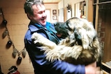 A big dog called Arden giving his owner a hug.