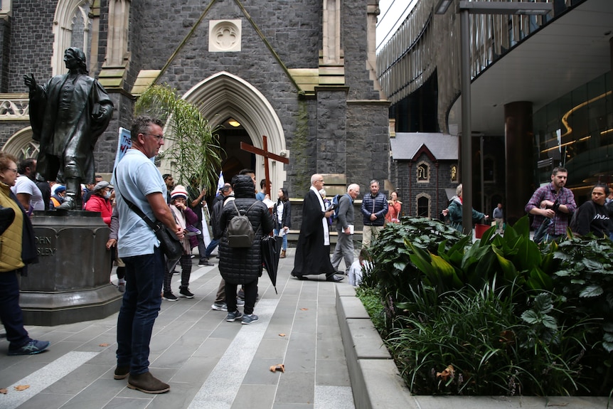 A priest leads worshippers on a Stations of the Cross procession in Melbourne on Good Friday.