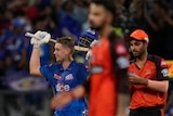 Australian cricketer Cam Green raises his bat in celebration after bringing up his hundred and winning an IPL game for his team.