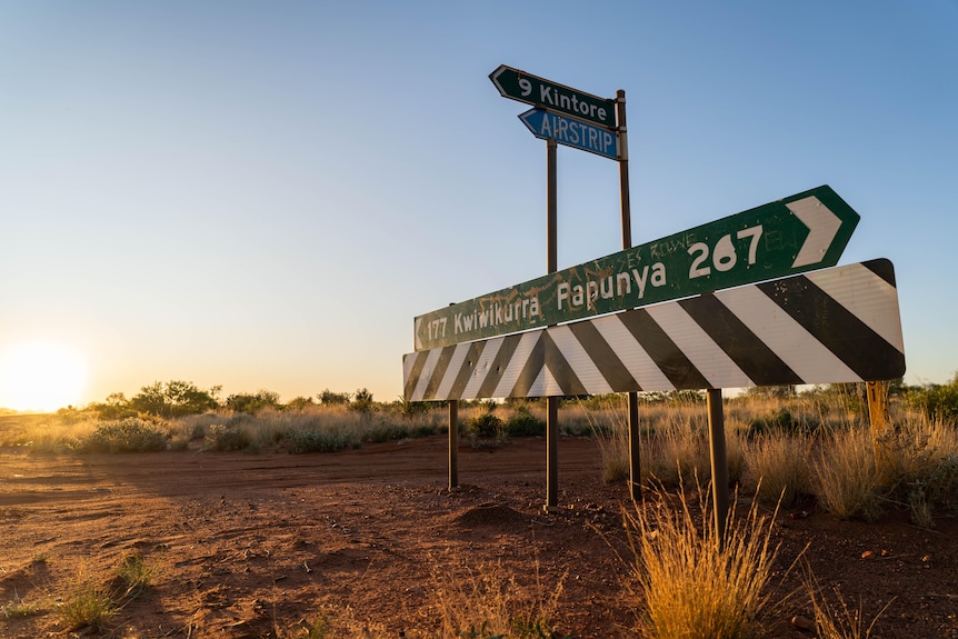 Signs pointing to different central Australian remote communities 