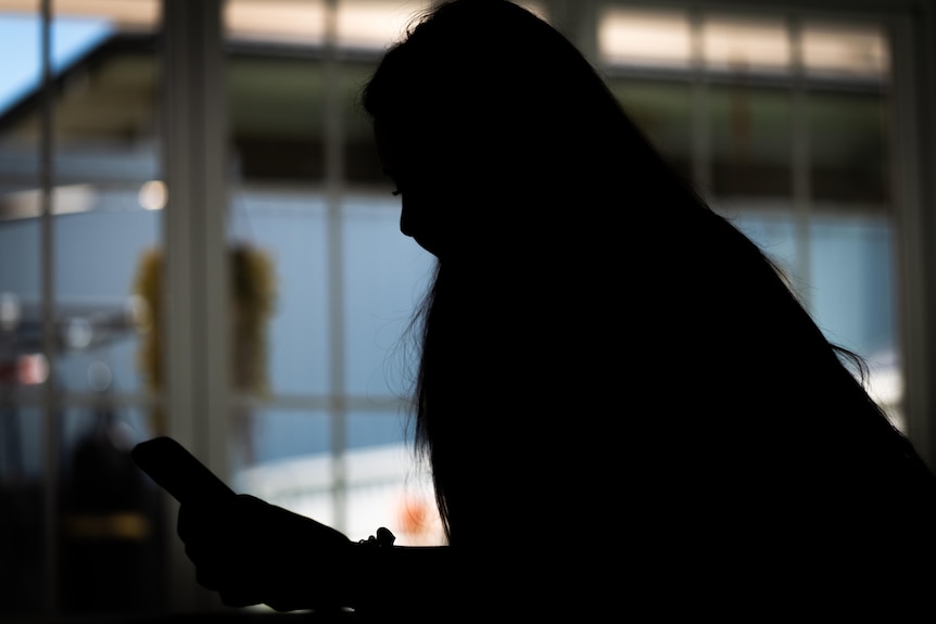 A silhouette of Jane holding a phone